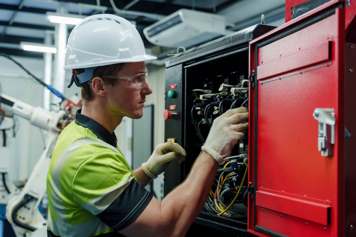 Electrician inspecting an electrical panel