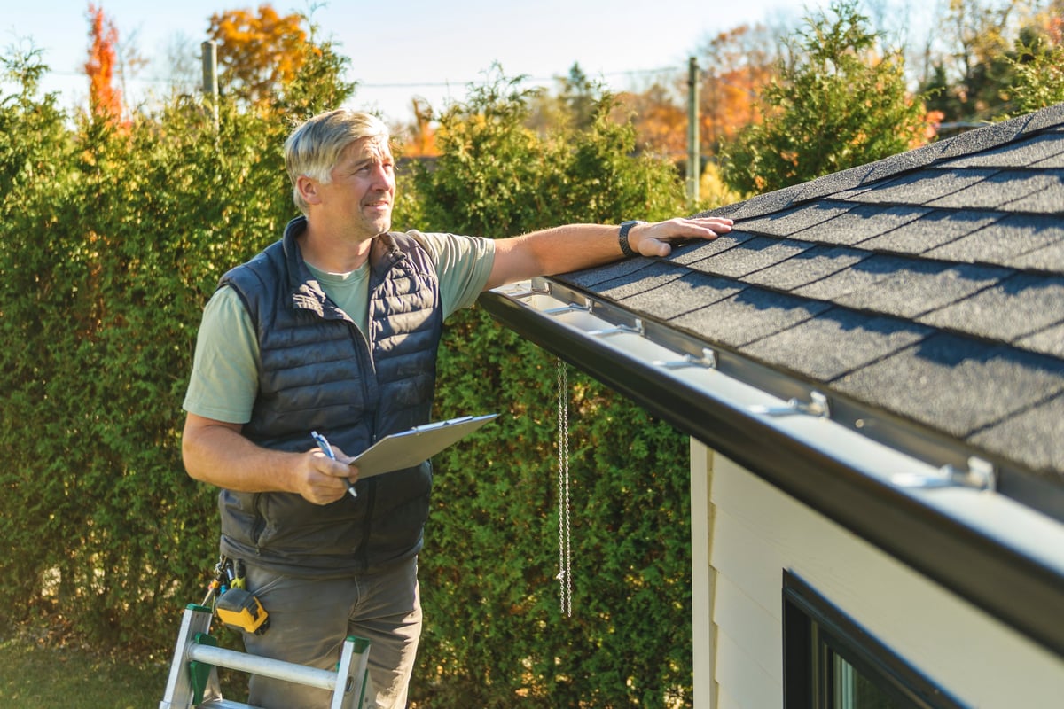 Worker inspecting a residential roof